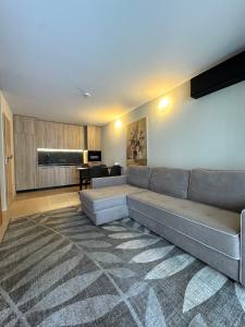 a living room with a large couch and a table at Vila Vika in Palanga