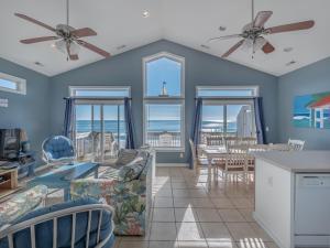 a living room with a view of the ocean at Daybreak on the Sand in Surf City