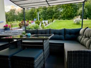 a patio with a couch and a table on a patio at Maiers Hotel in Bayerisch Eisenstein