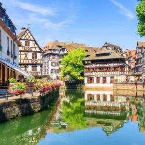 a group of buildings next to a river at General Suite - Strasbourg Hyper Centre in Strasbourg +18 photos