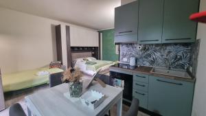 a kitchen with a bed and a table in a room at appartamento Margherita in Crespina