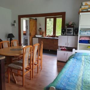 a kitchen and dining room with a table and chairs at Wiolinkowo in Sarnaki +19 photos