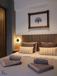 a bedroom with a large bed with two towels on it at Avra Studio Kastoria in Kastoria