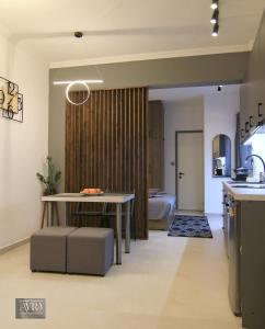 a living room with a table and a bedroom at Avra Studio Kastoria in Kastoria