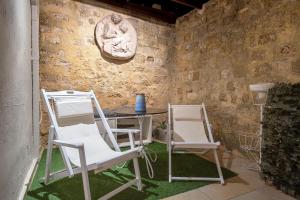 two chairs and a table in a room at Old Town Corner Luxury Studios in Rhodes Town