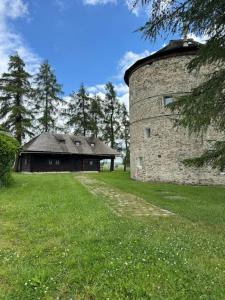 a stone building in a field next to a grass field at Dřevěnice in Němčice +6 photos