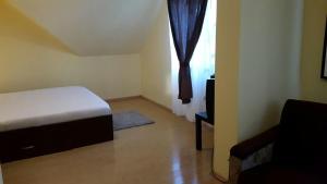 a small bedroom with a bed and a window at Pensiunea Family Zone in Roşiori de Vede +14 photos