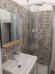 a bathroom with a sink and a shower at Il Canto del Gallo in Crotone +11 photos