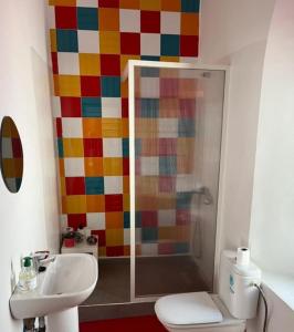 a bathroom with a shower with a colorful wall at Riad Tazi Casablanca in Casablanca