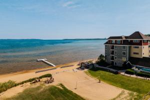 a building on a beach next to the water at Tamarack Lodge in Traverse City