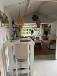 a kitchen and living room with a table and a couch at Huisje op de dijk in Kortenhoef +21 photos