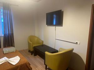a hotel room with a bed and a tv on the wall at Eden hostel in Tirana