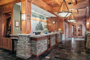 a large lobby with a stone bar in a lodge at Tamarack Lodge in Traverse City +8 photos