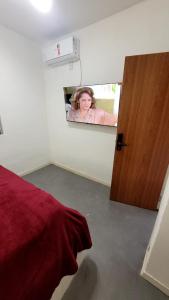a picture of a woman in a mirror in a room at Pousada Gaturama Village in Corumbá