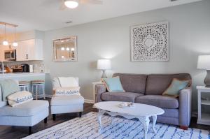 a living room with a couch and a table at Doves Landing in Surf City