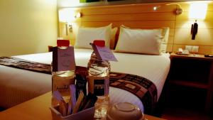 a hotel room with a bed with two bottles on a table at Crystal Hotel in Amman