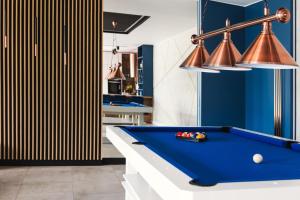 a pool table in a room with blue walls at Domek Gucci in Jejkowice +2 photos