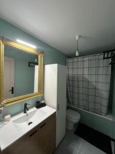 a bathroom with a sink and a mirror and a toilet at Los Bell@s in O Porto de Espasante +11 photos