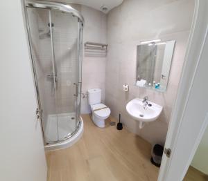 a bathroom with a shower and a toilet and a sink at La familia in Santa Ana (Urb. Riachuelos 2) +31 photos