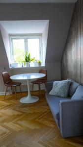 a living room with a couch and a table and a window at Cosy room in residential part of Copenhagen, with free street parking and shared bathroom in Copenhagen