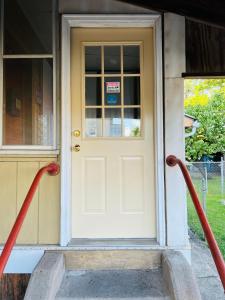 une porte d'entrée d'une maison avec des tuyaux rouges dans l'établissement Pacifico's Place "B", à Hartford