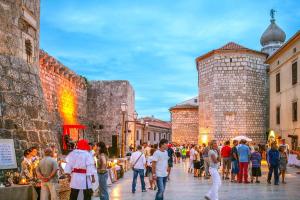 a crowd of people walking around a street in a city at Noel's dreams in Praputnjak