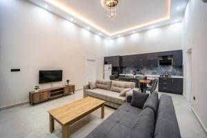 a living room with a couch and a table and a kitchen at Villa Huzurlu in Kaş