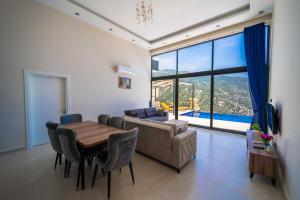 a living room with a table and a couch at Villa Huzurlu in Kaş