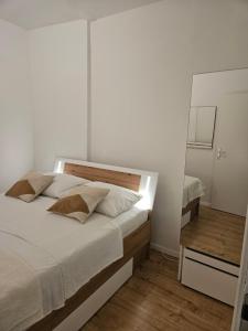 a bedroom with a large bed and a mirror at Apartment Marin in Split
