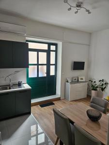 a kitchen and dining room with a green door at Apartment Marin in Split