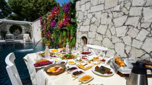 a table with plates of food on top of it at Lulu Inn Cesme in Çeşme