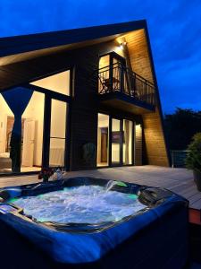 a large hot tub in front of a house at Zenit Chalet Sohodol-Bran in Sohodol