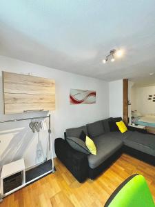 a living room with a black couch in a room at Luckenberg in Fulda +9 photos