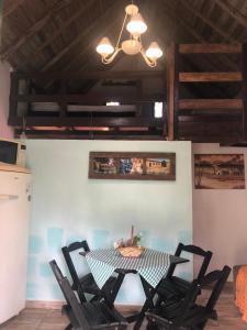 a dining room with a table and chairs at Pouso das Águias in Nova Veneza