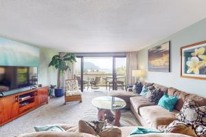 a living room with a couch and a tv at Hanalei Bay Resort 6222 in Princeville