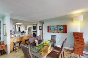 a dining room and kitchen with a table and chairs at Hanalei Bay Resort 6222 in Princeville