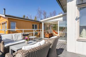 a patio with wicker chairs and a table at Nordic lights villa in Sigtuna