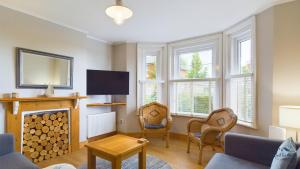 a living room with a fireplace and a tv at East View, a stunning home from home in St Helens, sleeps 6. in Saint Helens