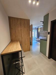 a kitchen and living room with a counter and a table at Anja & Ogo apartments sea View & Pool in Petrovac na Moru