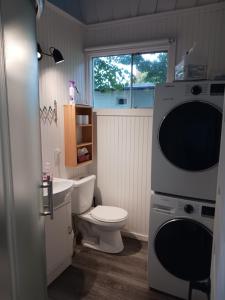 a bathroom with a toilet and a microwave at Maison Marcotte in Saint-Michel