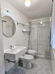 a bathroom with a sink and a toilet and a shower at Narissara apartment in La Spezia