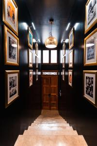 a hallway with pictures on the walls and a door at Suite 1 at Palazzo Seraphim Boutique living in St Julians in St Julian's