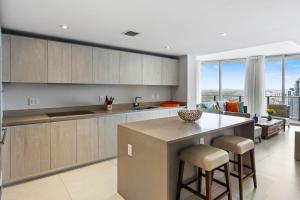 a kitchen with a island with a counter top at Corner condo, Wraparound Balcony Ocean and City Views at LYFE Resort in Hollywood
