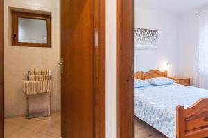 Postel nebo postele na pokoji v ubytování Apartmani Pina