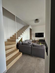a living room with a couch and a staircase at Casa Miele in Omiš