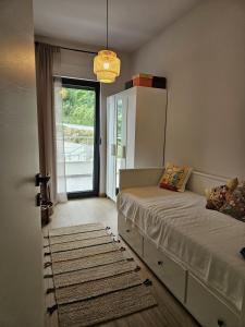 a bedroom with a bed and a door with a window at Casa Miele in Omiš