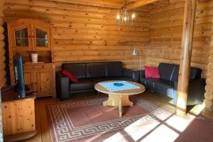 a living room with a couch and a table in a cabin at House, Wiefelstede-Lehe in Wiefelstede