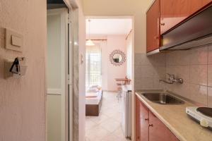 a kitchen with a sink and a counter top at Iliadis House in Sarti +23 photos