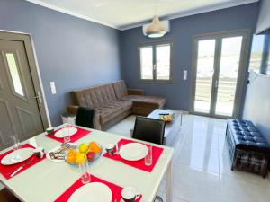 a living room with a table and a couch at Elafonisi Paradise with Parking, WiFi, - Walking Distance to the Beach in Elafonisi