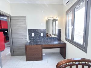 a bathroom with a sink and a mirror at Elafonisi Paradise with Parking, WiFi, - Walking Distance to the Beach in Elafonisi